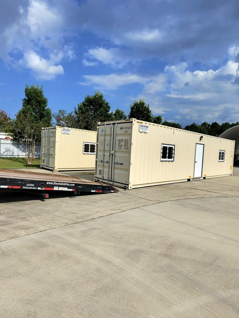 Custom shipping container office exterior delivered in Houma, LA on maritime staging yard with steel security bars